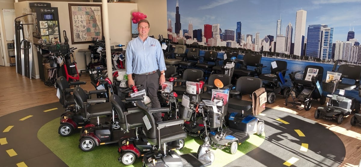 Midwest Mobility owner Geoff Hanson standing in showroom around mobility equipment